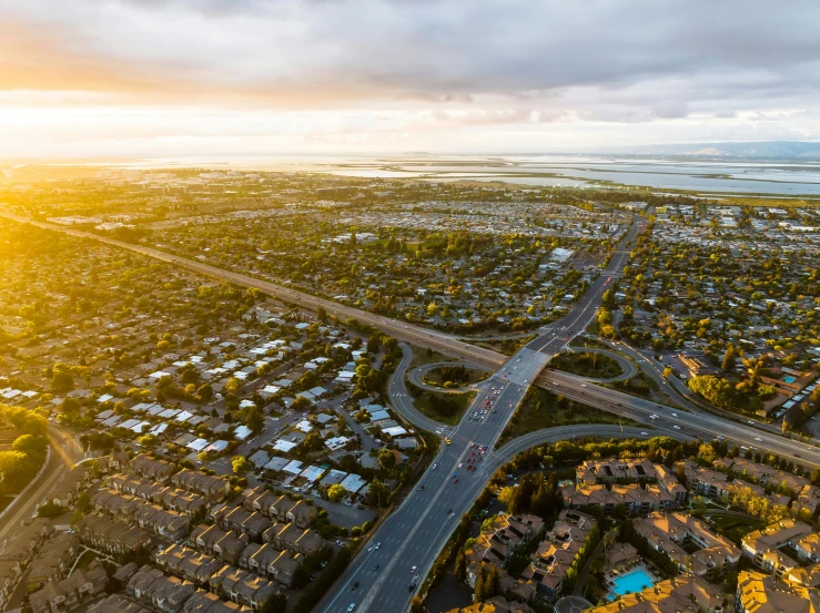 an aerial view of an intersection, highway and ocean