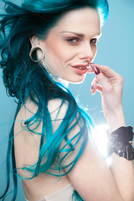 a woman with blue hair brushing her teeth