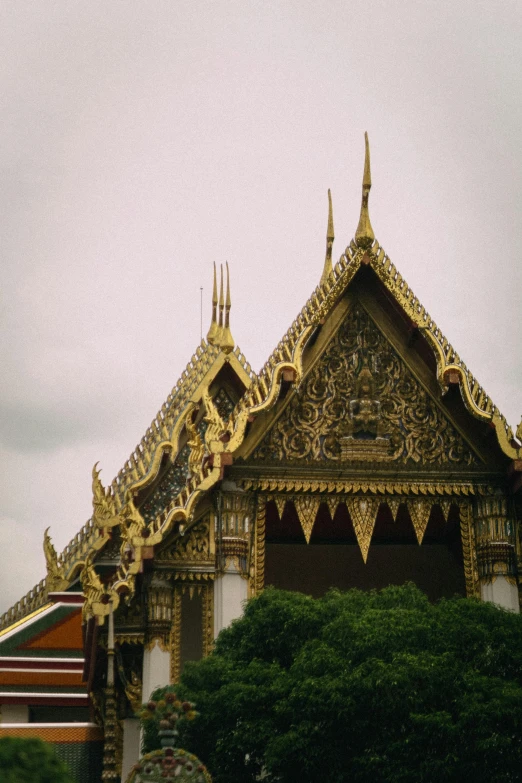 an ornate roof that has been designed and is gold