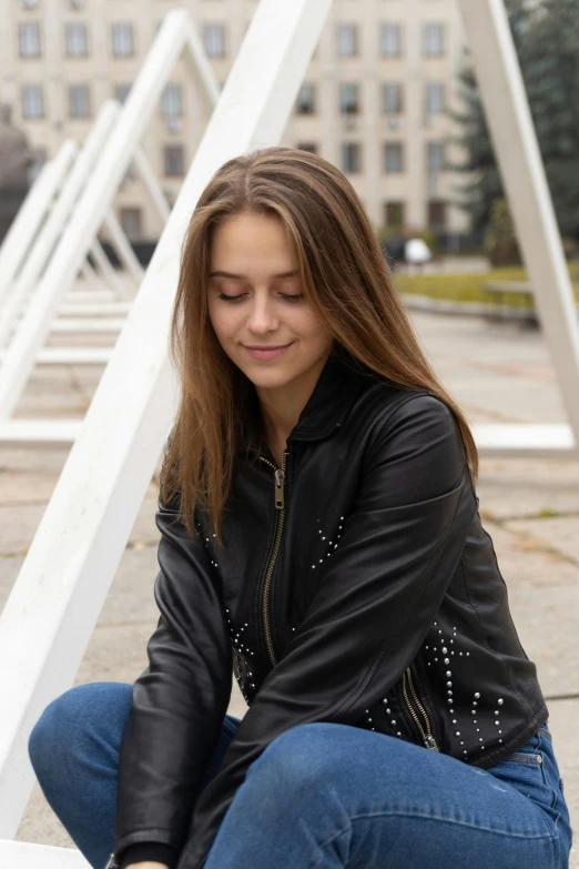 a girl squats on stairs with her eyes closed