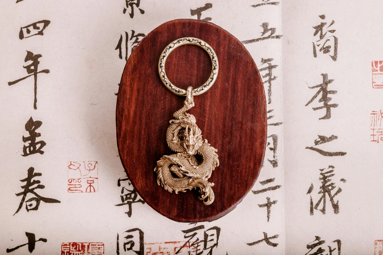 a key ring sitting on top of a wooden plaque