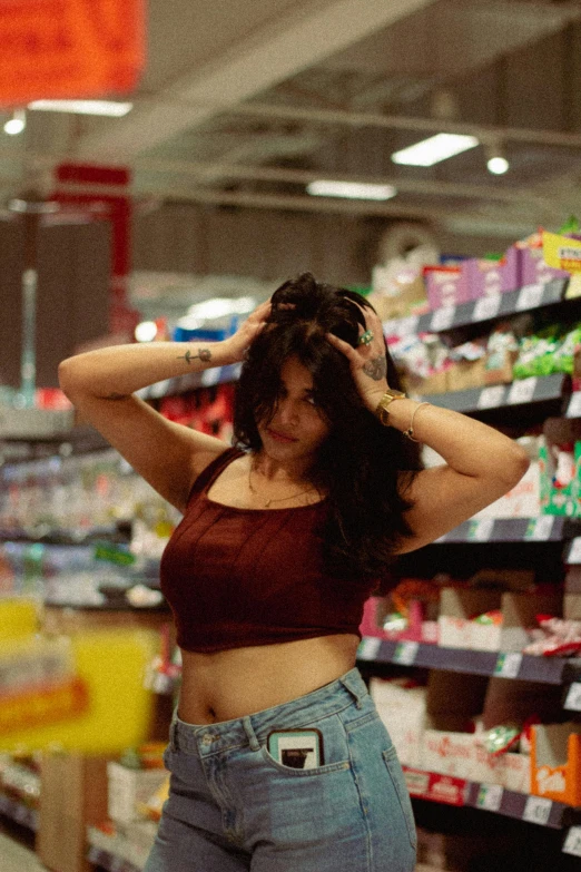 a girl with long hair is standing in a store aisle