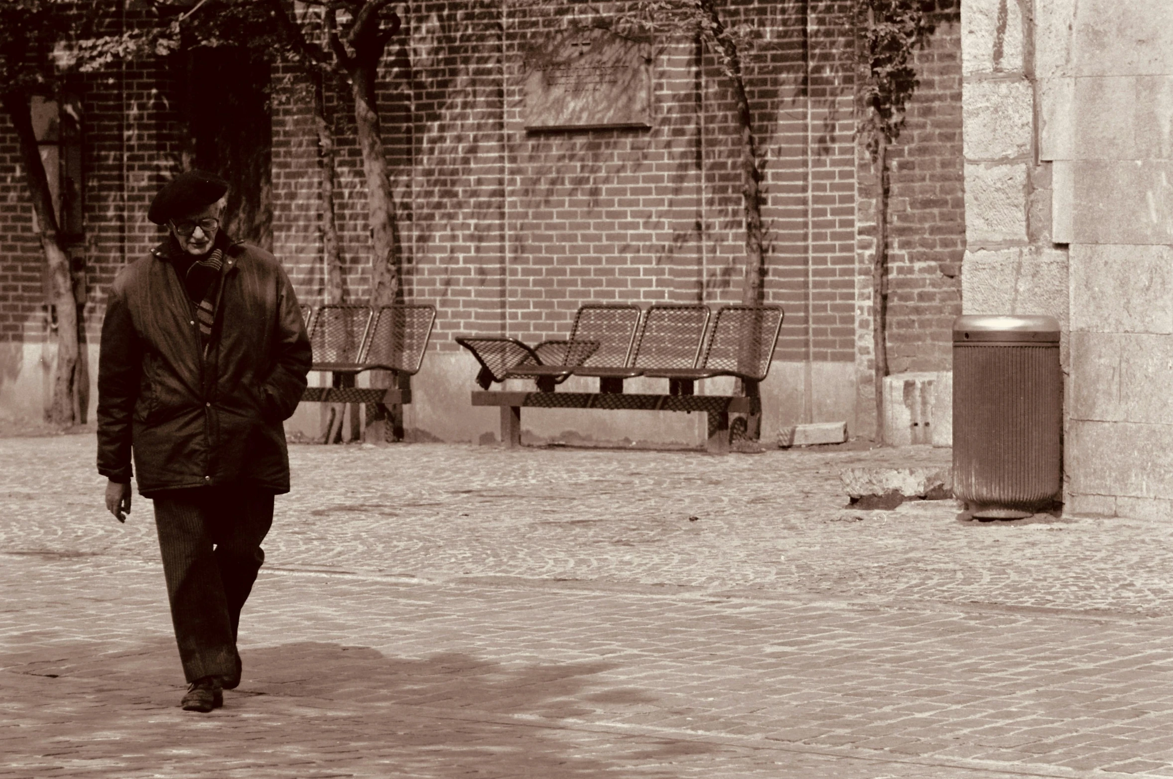 a man walking on the street in black and white