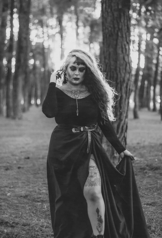 a woman wearing an old fashion dress in the woods