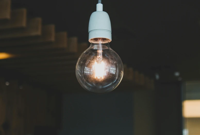 a lightbulb with one light turned on and the other being used to light a lamp