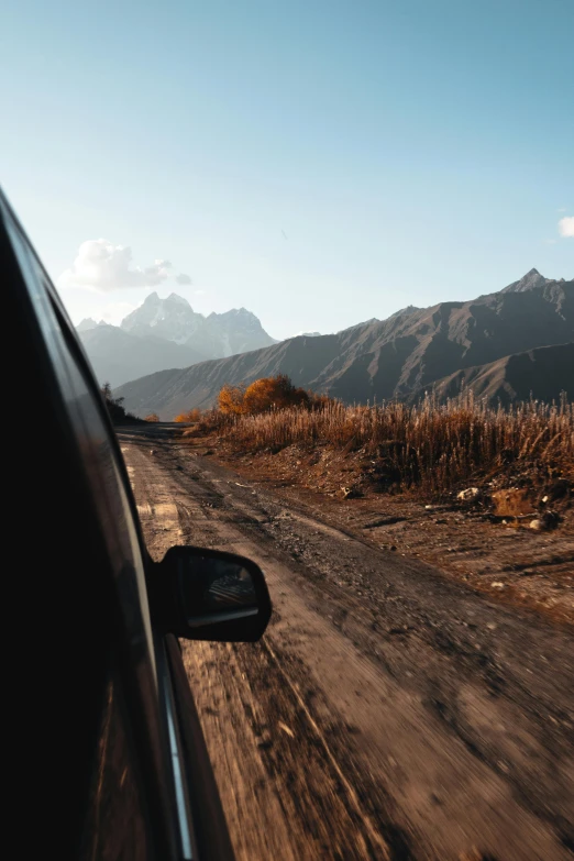 a scenic road and the mountains with fall colors