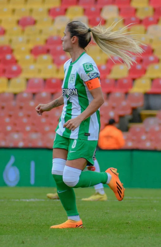 a women's soccer player is running down the field