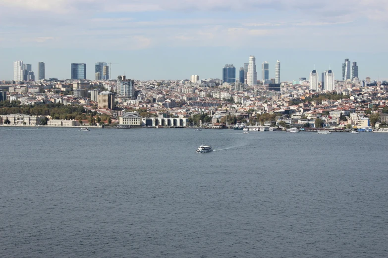 boats floating in the water near a city