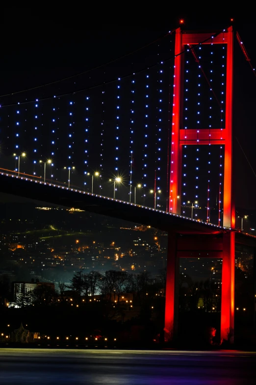 a very long and tall bridge with a bunch of lights on it