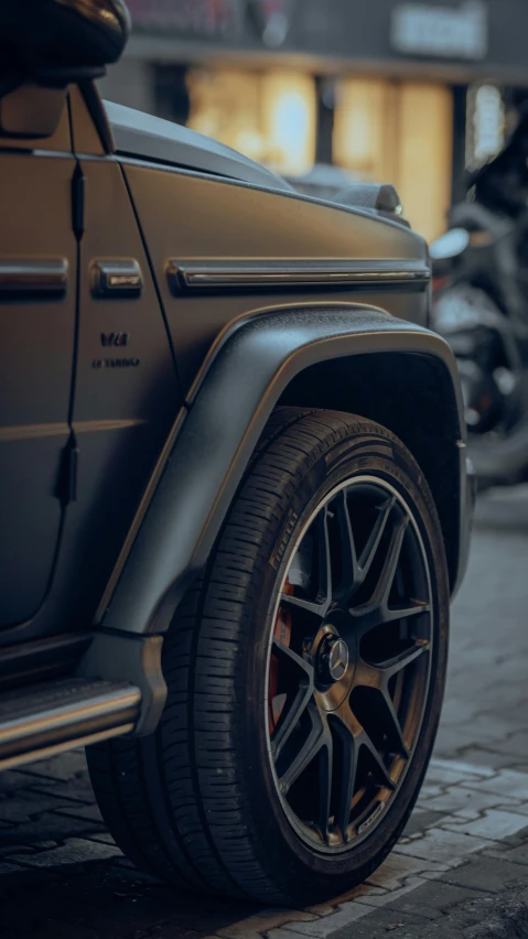 a grey suv with two black tires is parked