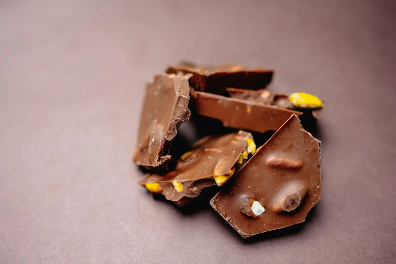 a table topped with pieces of chocolate and candy