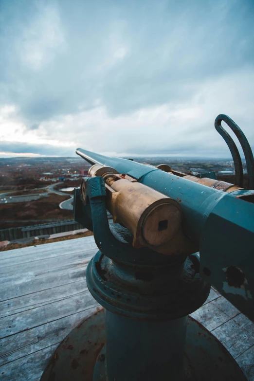 cannon atop structure in outdoor setting during cloudy day