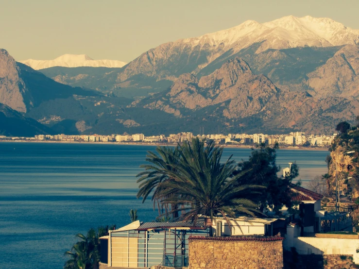 a mountain range behind a body of water