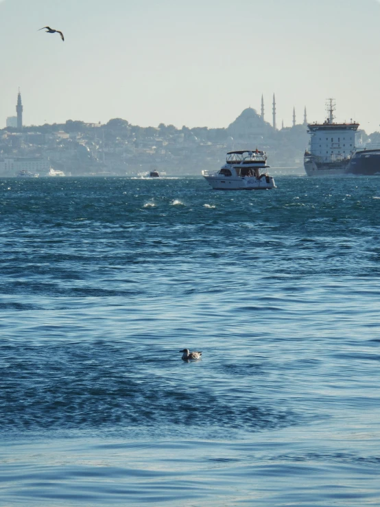 there is a large boat in the water next to a yacht