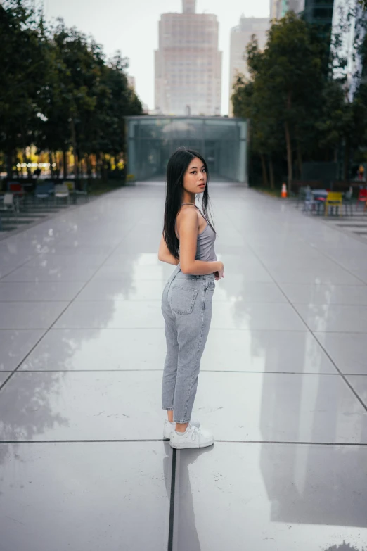 woman standing on cement area in the rain