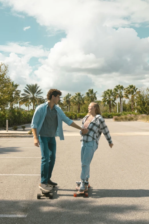 a man on a skateboard with a woman holding hand