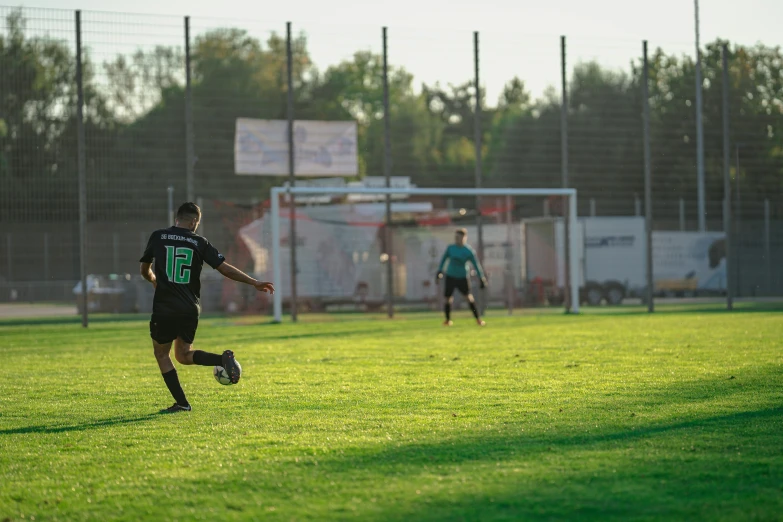 two people playing soccer in an open field