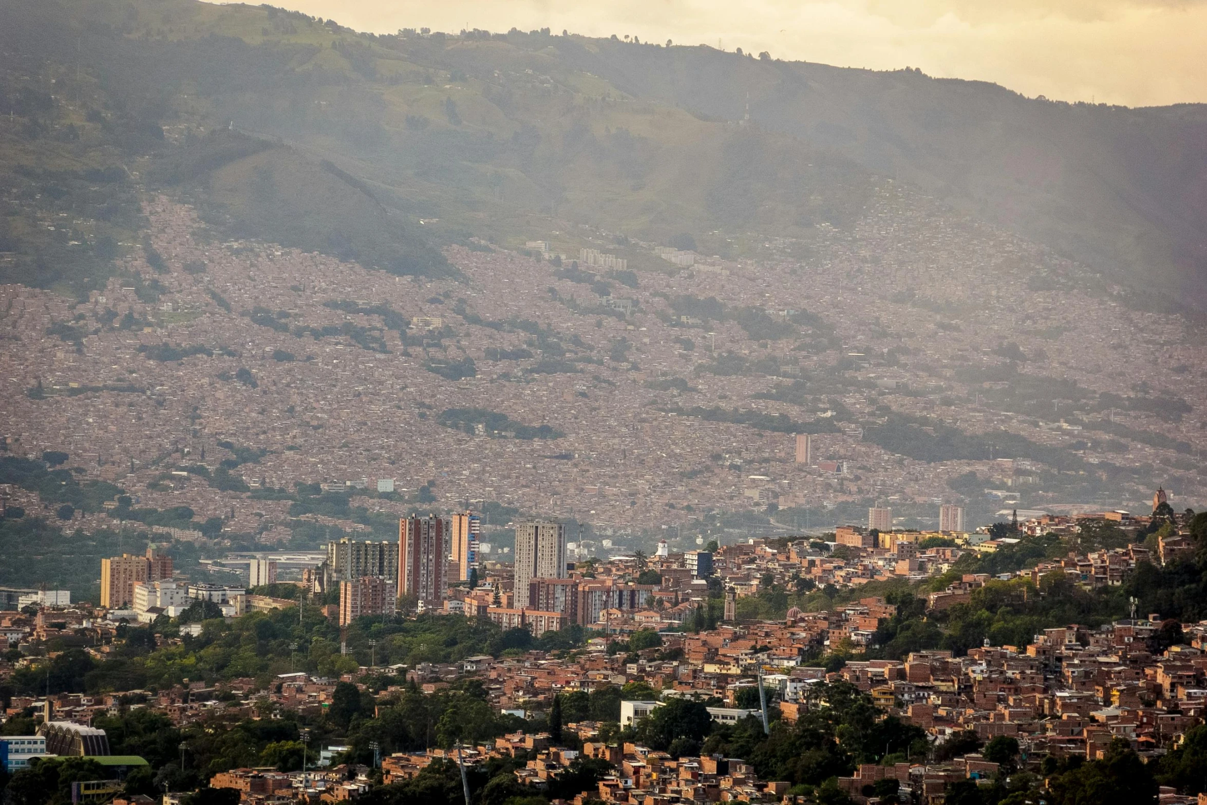 the cityscape of a hill town is in the background