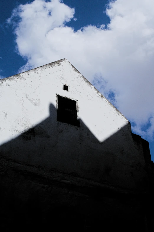 a building with a clock displayed against a cloudy sky