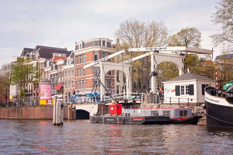 several large boats docked in a harbor on the side of a city