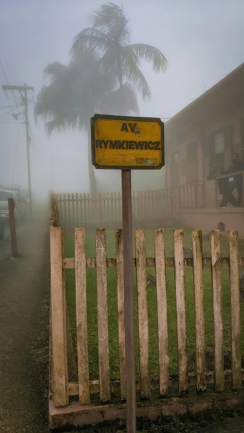 a sign on a post in the rain