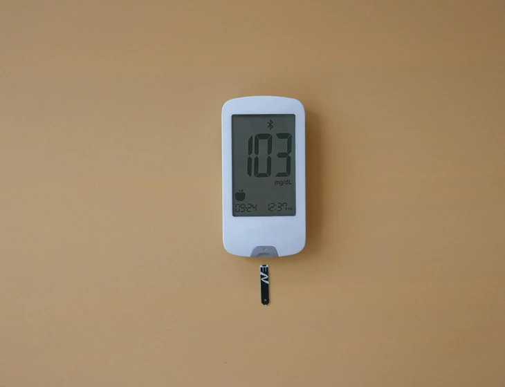 an electronic clock on the wall showing it is noon