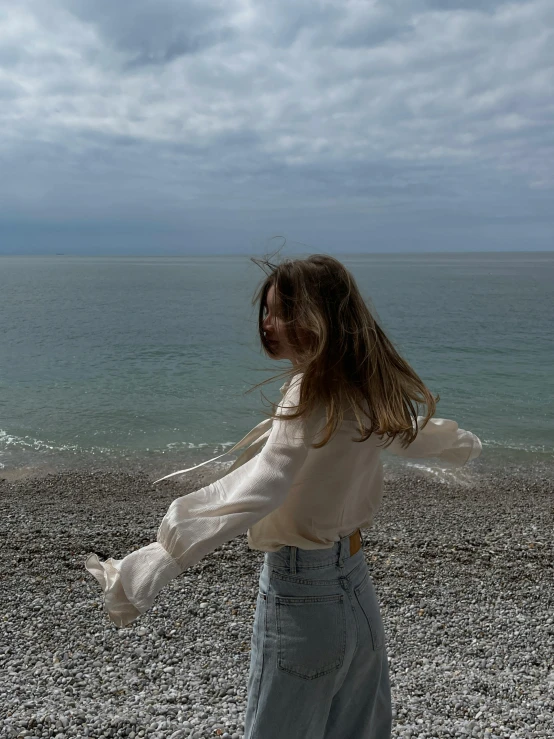 a person standing on a beach with a cellphone