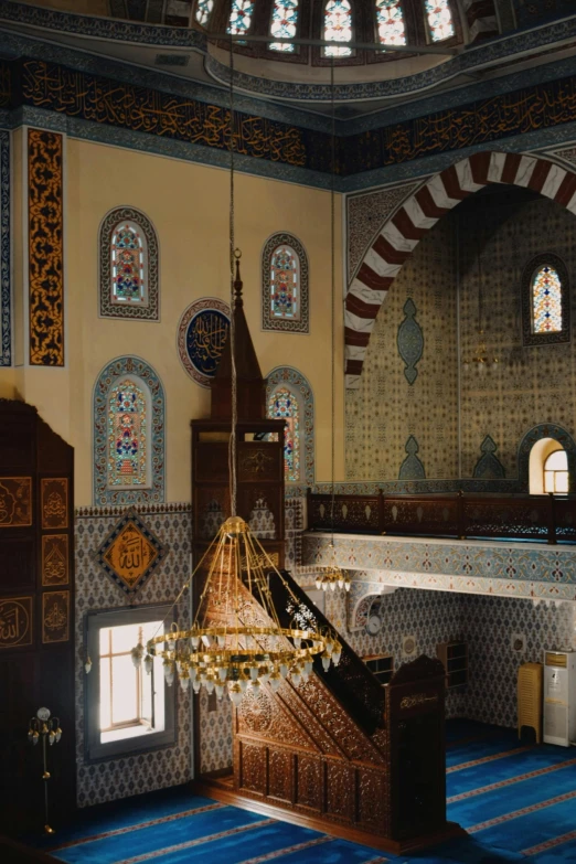 the room in the building has lots of windows and decorative tiles