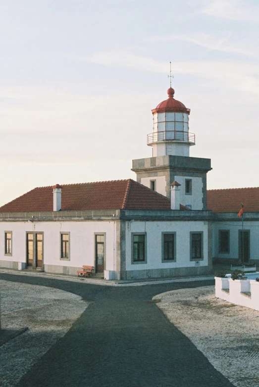 the lighthouse on the small building is white with red roof