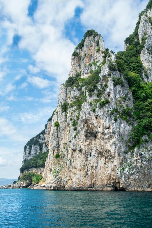 a rocky hill on the side of a body of water