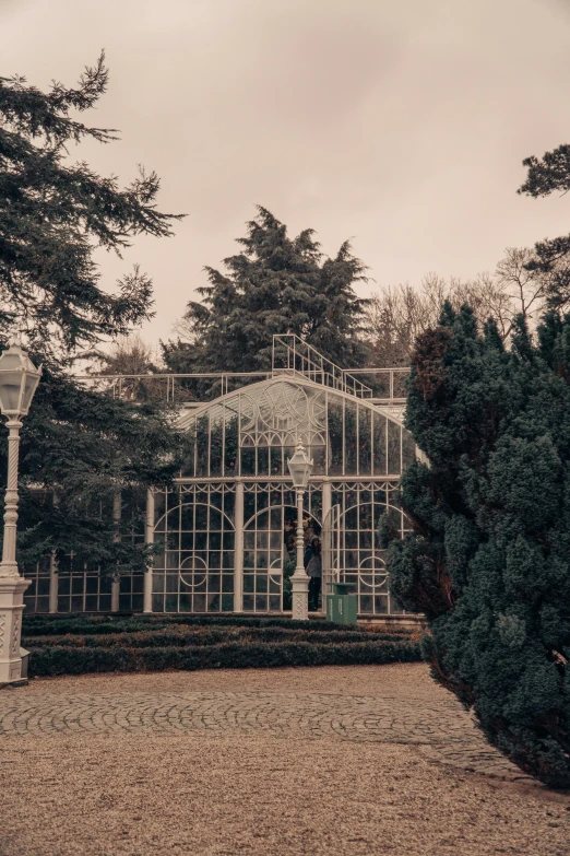 a garden with a glass building and trees