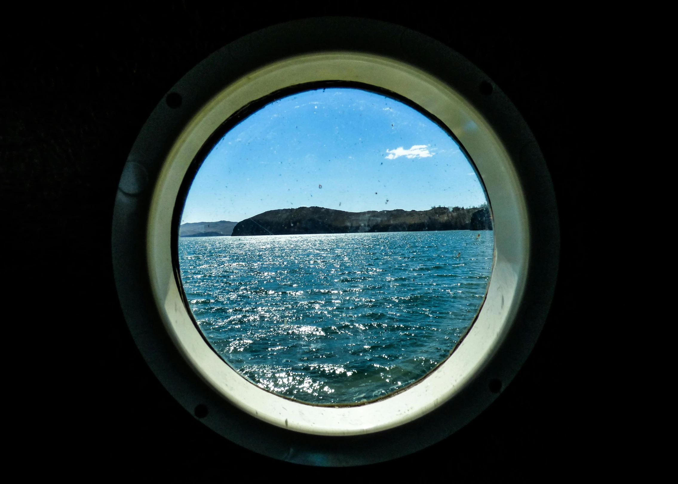 a large port window overlooking the ocean