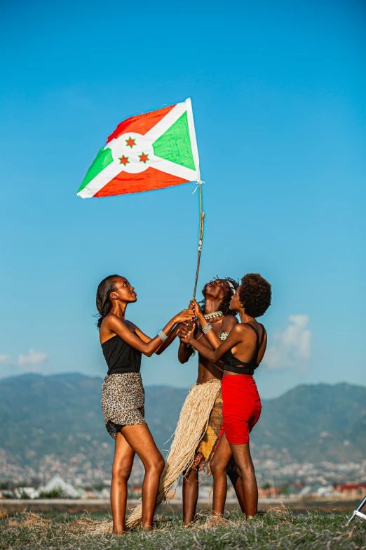 three young women in short skirts hold a flag