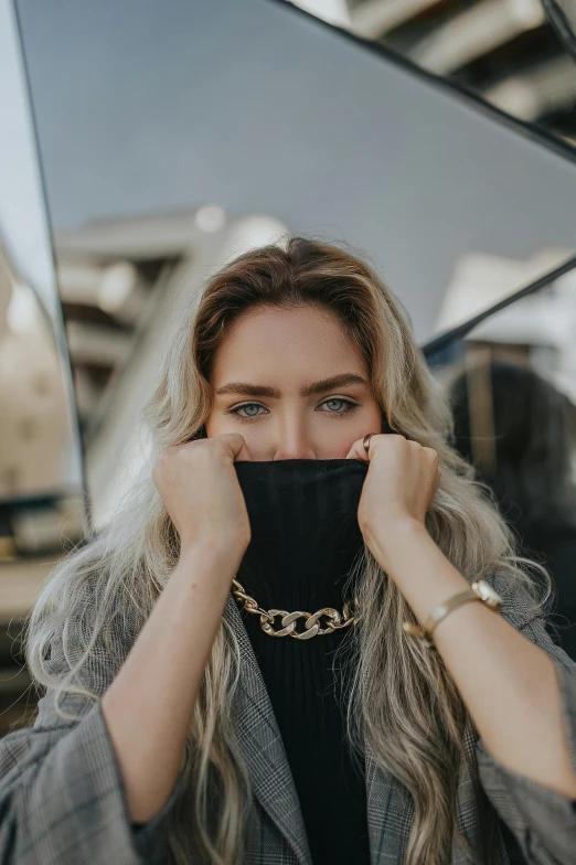 a woman wearing a black choker covering her face