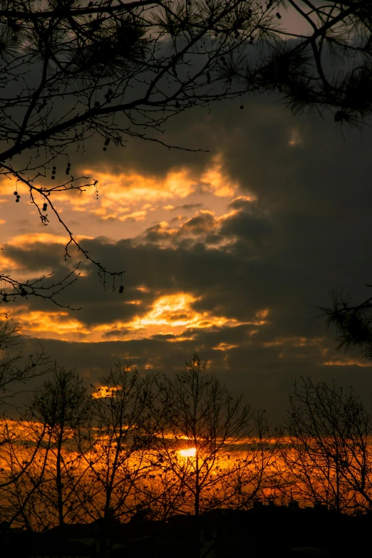 a lone airplane in the distance, as the sun sets