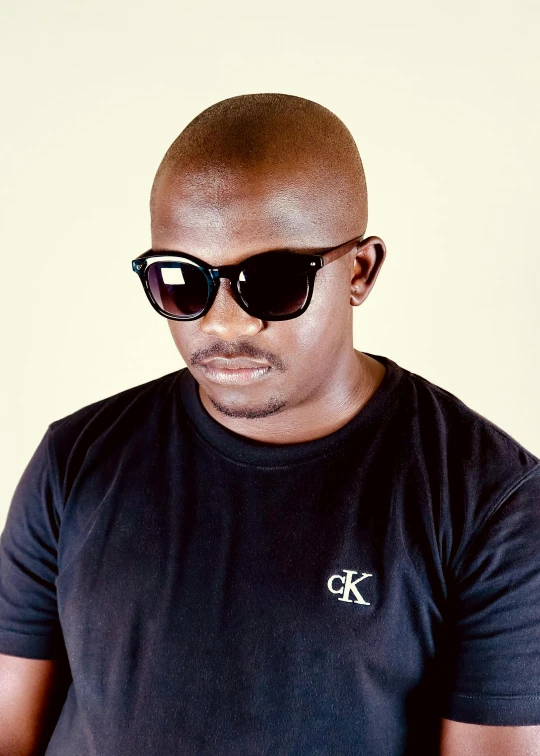 a man wearing sunglasses and a black t - shirt