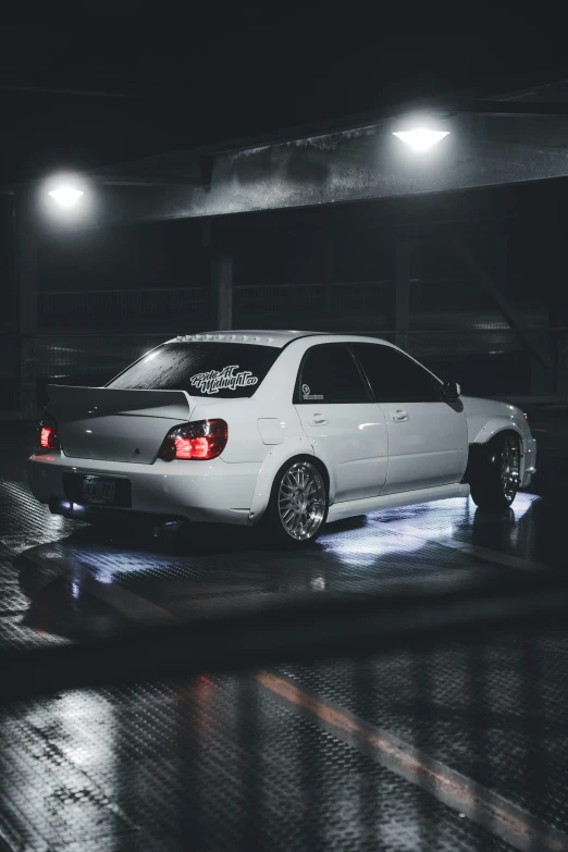 a white car parked in a parking garage