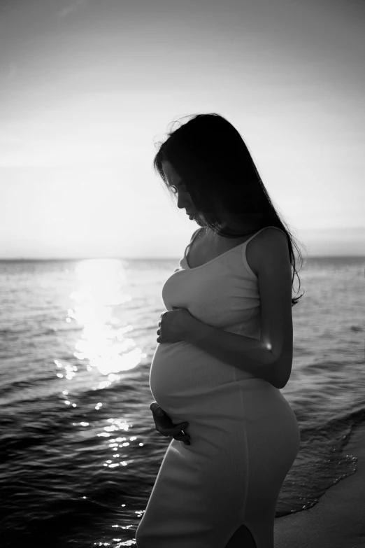 the pregnant woman is standing on a boat