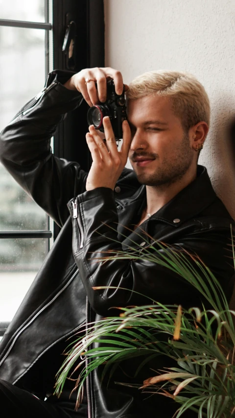 a man looking at his phone while sitting down