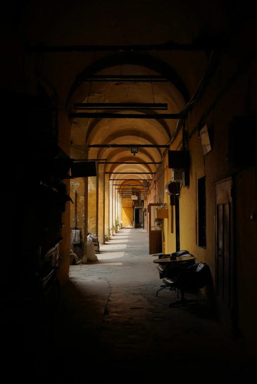 a long narrow hallway that is between two buildings