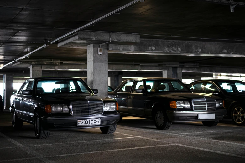 an empty parking garage with many vehicles parked inside of it