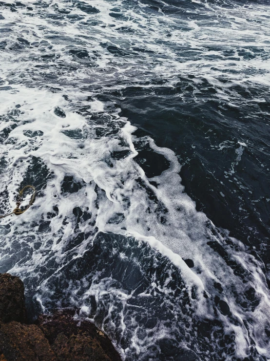 view from a sea cliff with rough white water