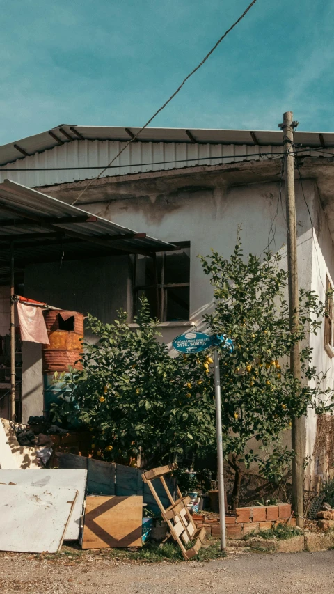 an old run down house with lots of trash piled around it