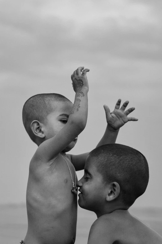 two young children are playing on the beach