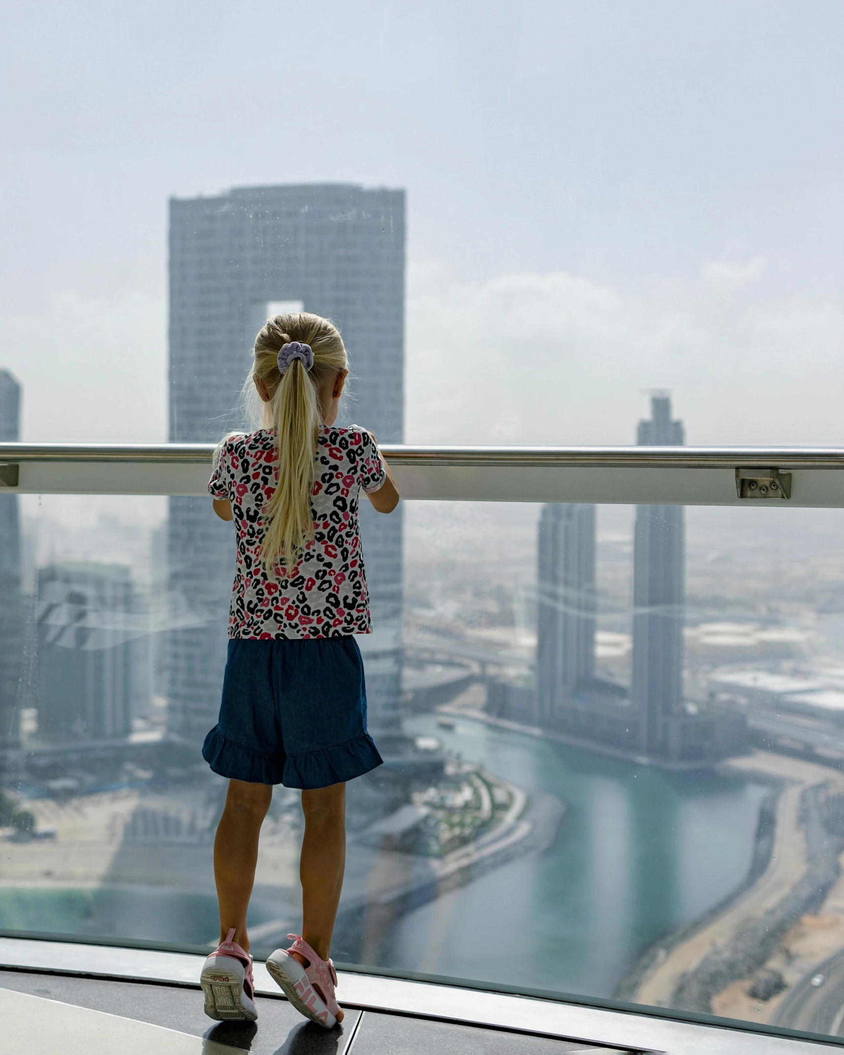 a child looking out at a city skyline