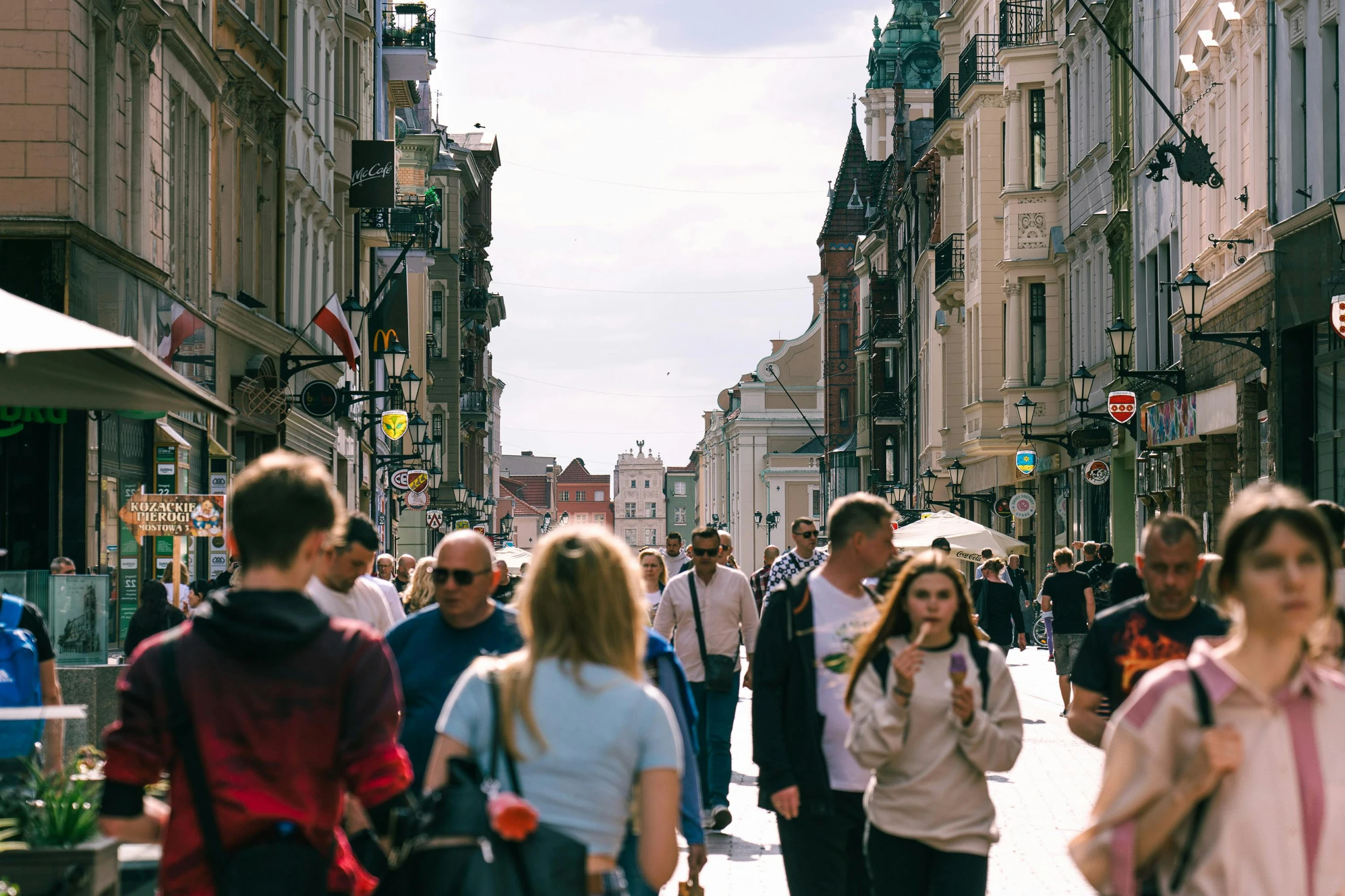 there is a crowd of people that are walking through the streets