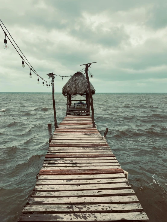 a large body of water with a pier in the foreground