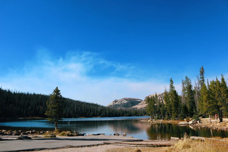 the view of a lake from an empty road