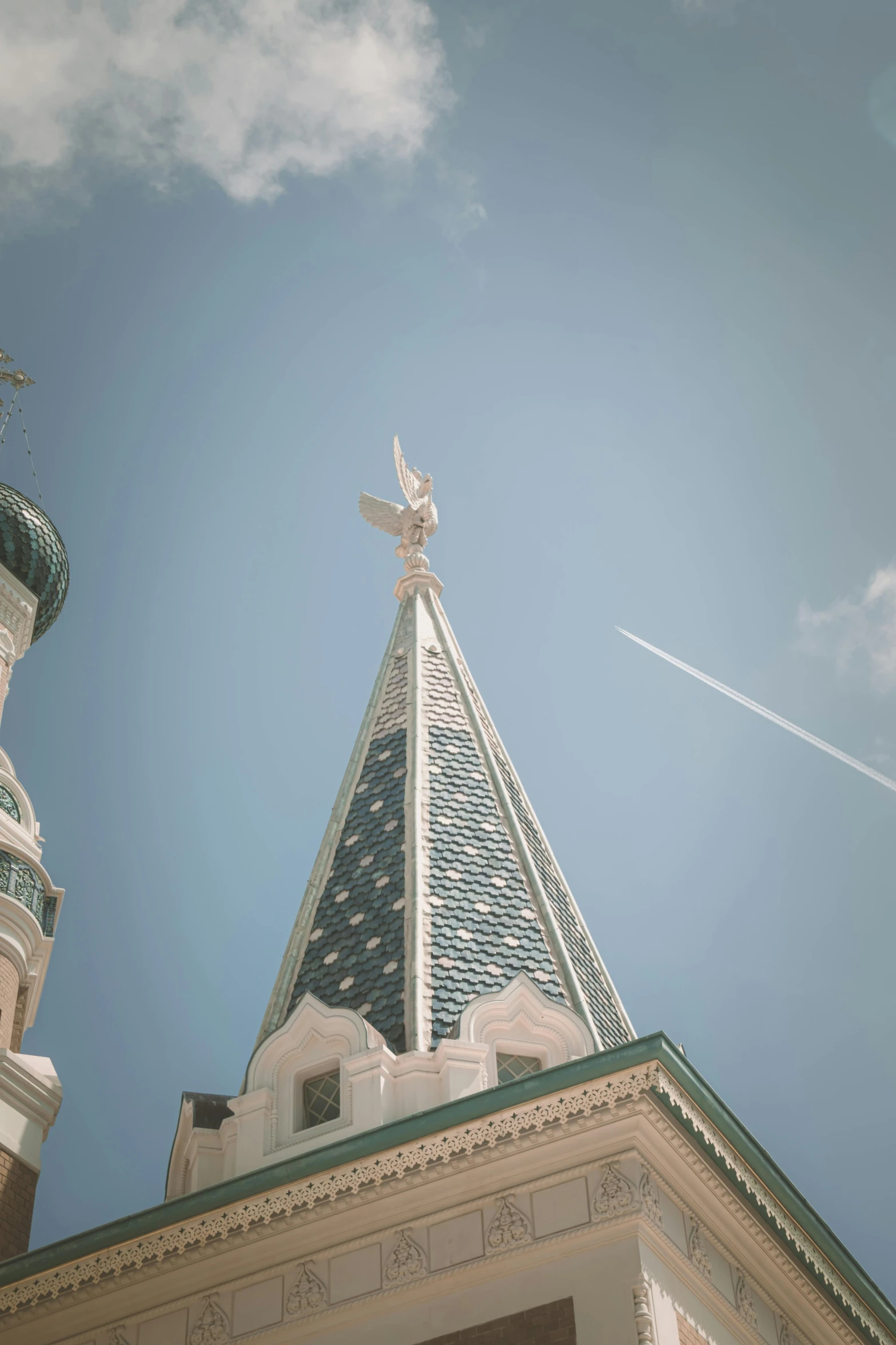 a cathedral clock tower against a blue sky