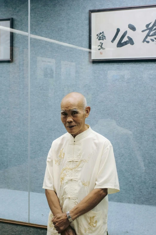 a man standing with a shirt with chinese writing on it